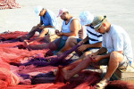Fishermen repairing nets